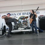 Robert Ross performing at the Riverhead Blues Festival w/Steve Holley (d) and Mark Dann (b) in 2009.
